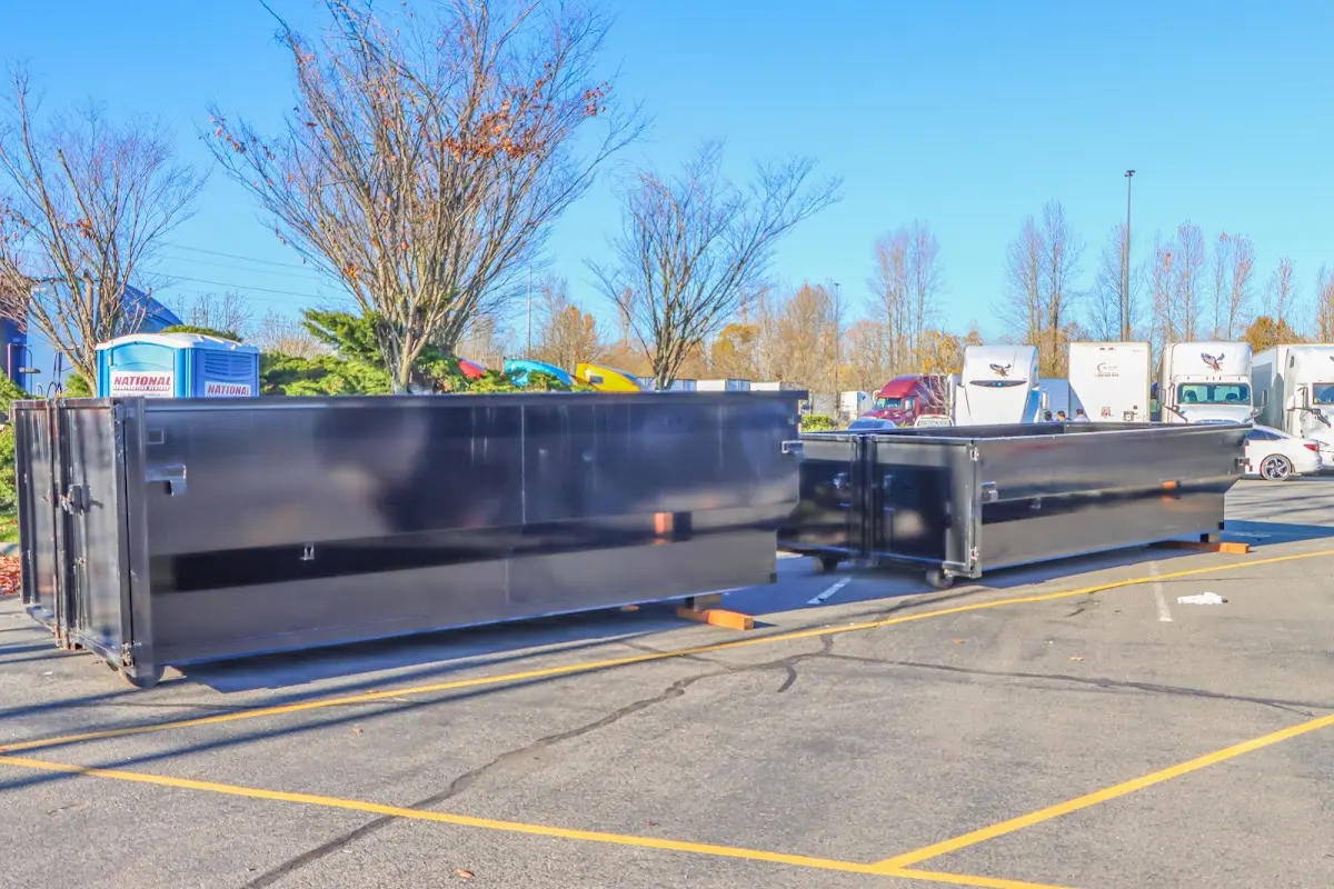 Professional dumpster rental service with roll-off container on residential driveway in Griffith